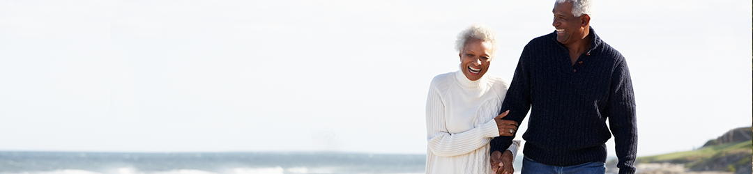 senior couple laughing on beach