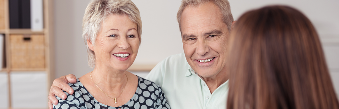 senior couple talking with advisor