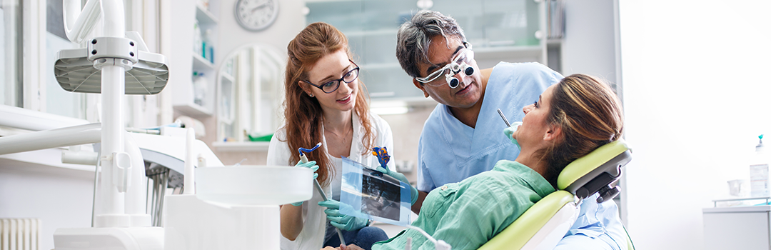 dentist and assistant working on patient