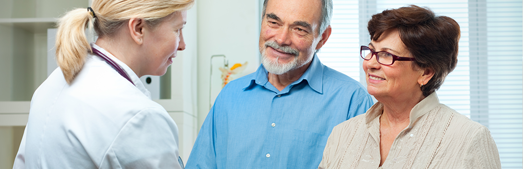 doctor talking with senior couple