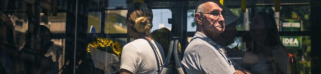 man on bus looking out window